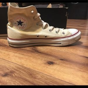 Cream colored Converse high tops shoes